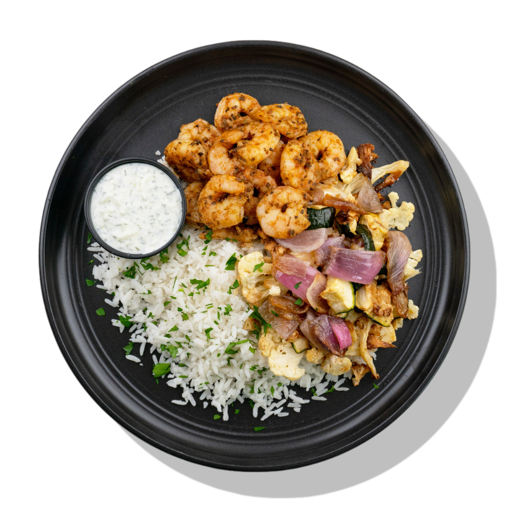 Moroccan Shrimp: Moroccan-spiced shrimp served with a side of roasted cauliflower, zucchini & red onion, white rice and cool & creamy tzatziki dipping sauce.
