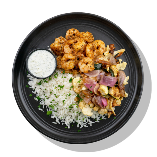 Moroccan Shrimp: Moroccan-spiced shrimp served with a side of roasted cauliflower, zucchini & red onion, white rice and cool & creamy tzatziki dipping sauce.