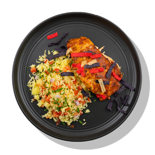 Salsa Ranch Chicken: A grilled chicken breast topped with creamy salsa ranch dressing, shredded cheddar cheese and crisp tortilla strips served with a side of pico de gallo yellow rice.